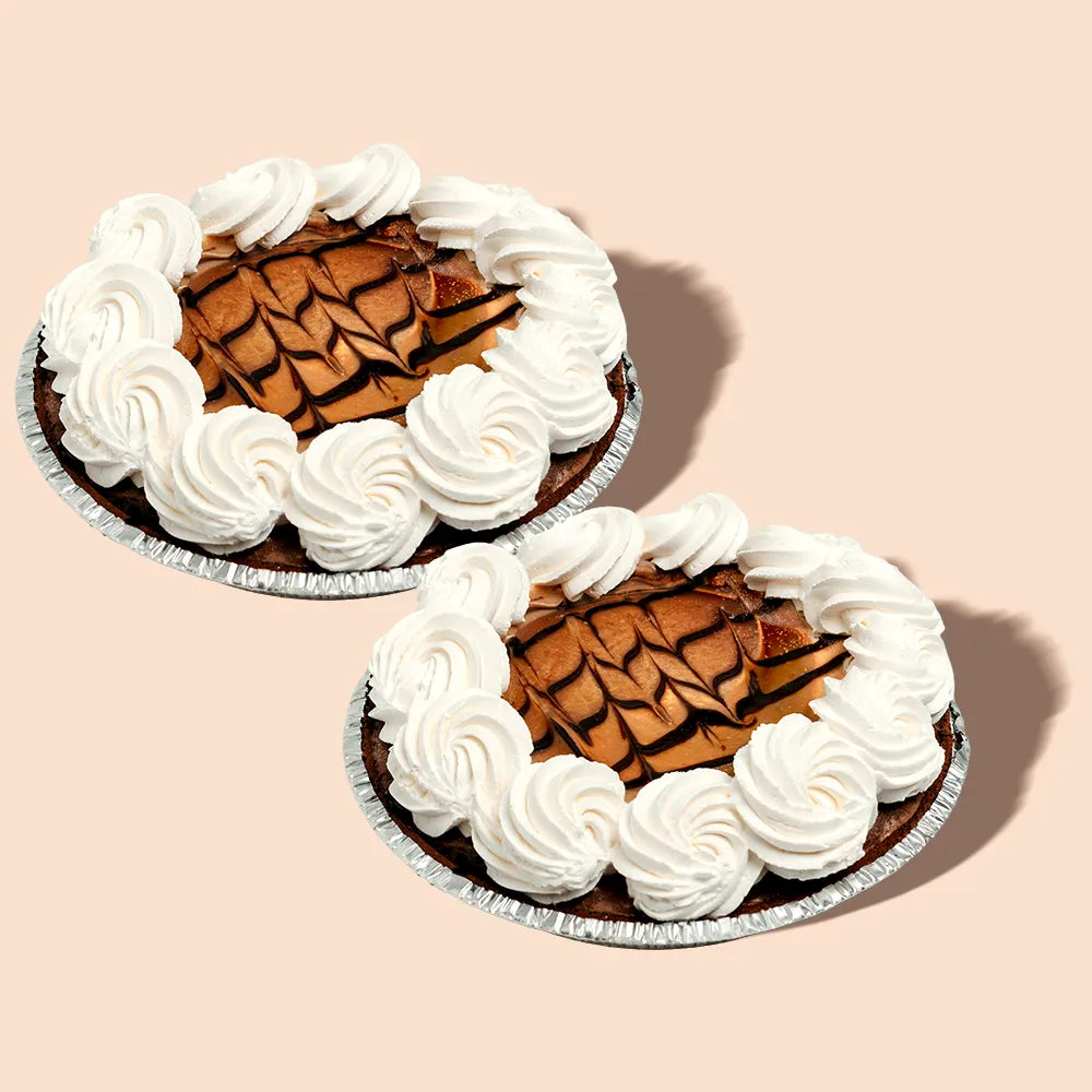 Two buckeye ice cream pies with whipped cream.