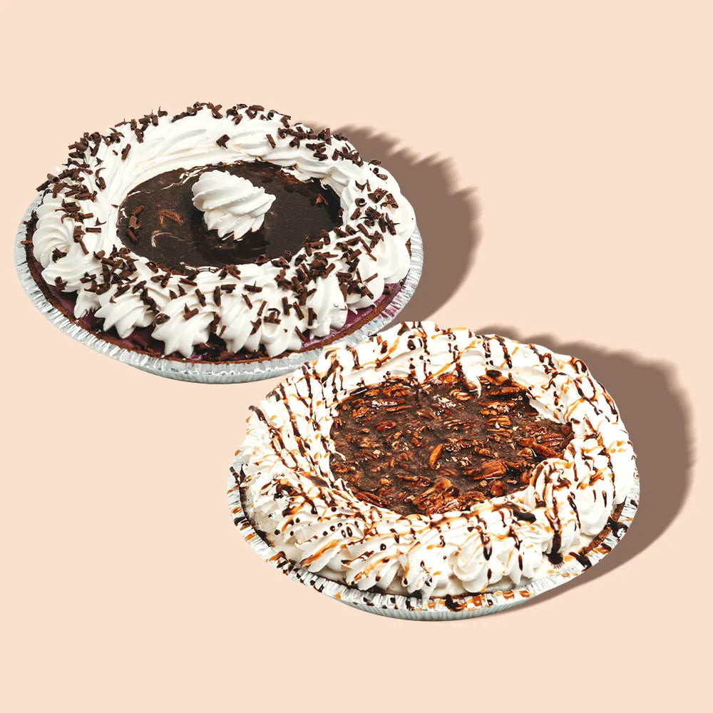 Two ice cream pies with whipped cream and toppings.