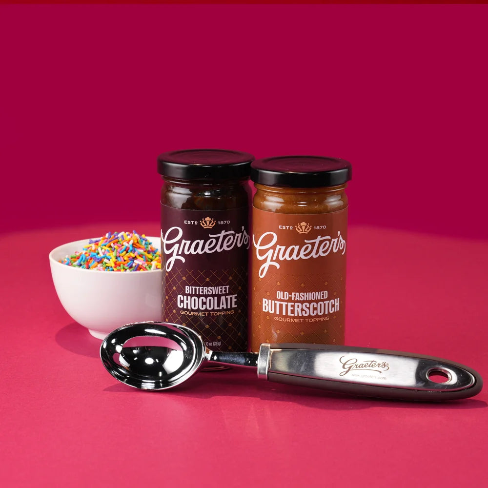 Two jars of Graeter's dessert topping with rainbow sprinkles, and an ice cream scooper.