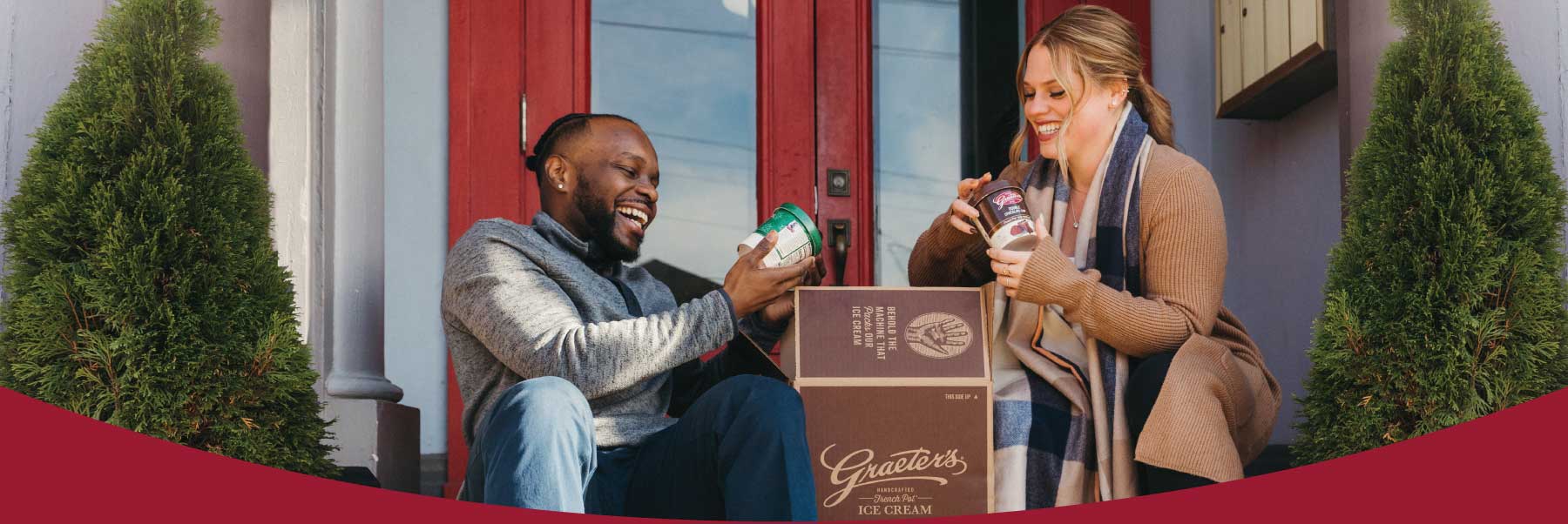 Couple opening Graeter's gift pack on doorstep