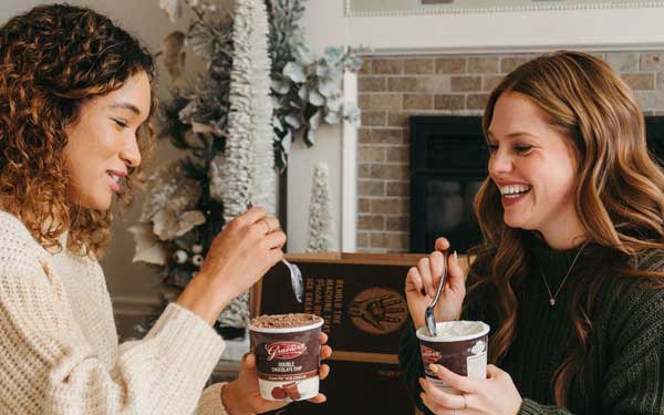 Two ladies enjoying pints of ice cream