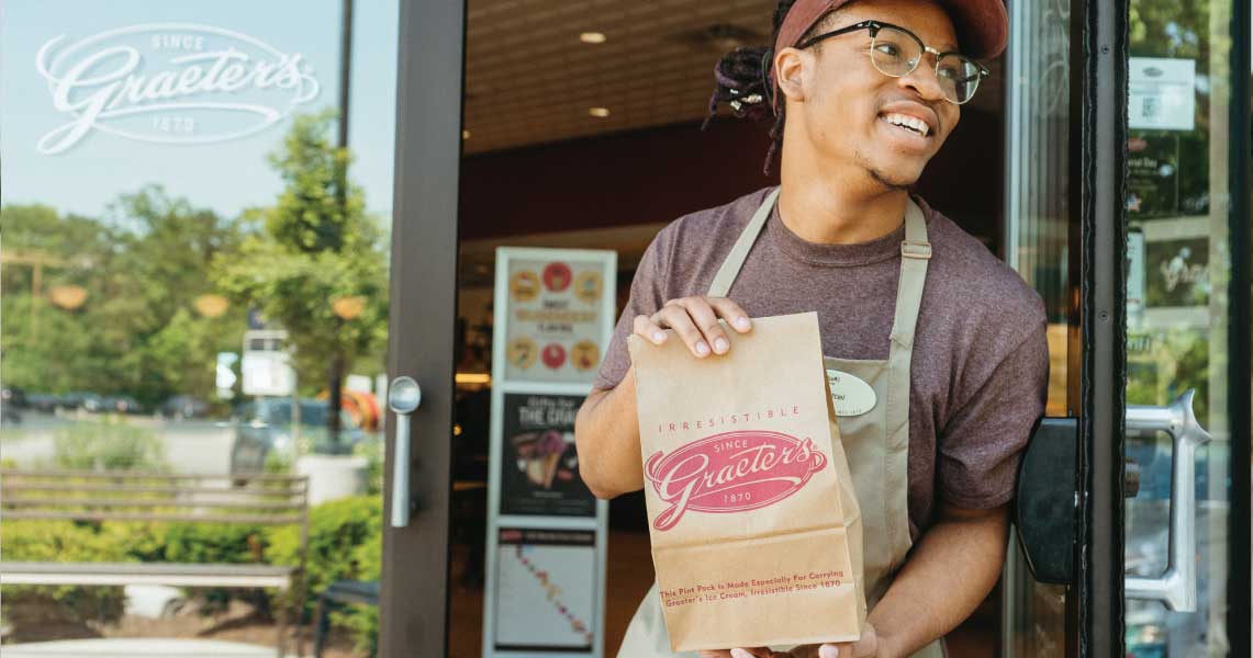 Employee With Ice Cream For Curbside Pickup