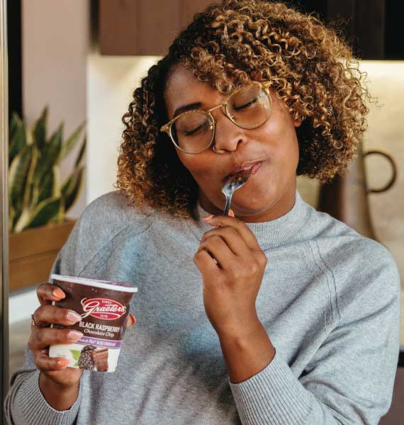 Woman eating a pint of ice cream